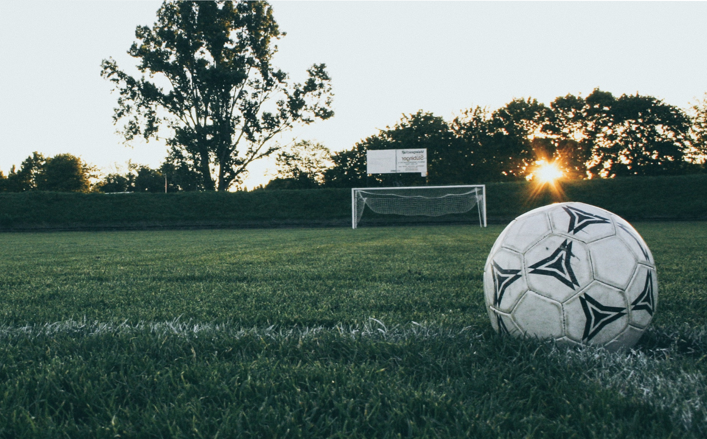 Homepage header image of soccer ball on a soccer field