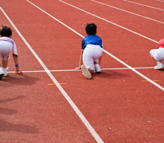 children stretching at a track